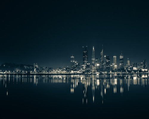 Perth city skyline at dusk over the Swan River
